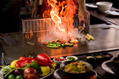 Chef preparing teppanyaki on a hot plate