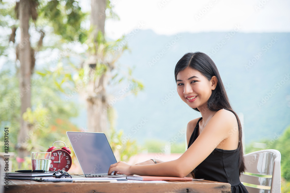 Young business woman working with laptop on workplace.