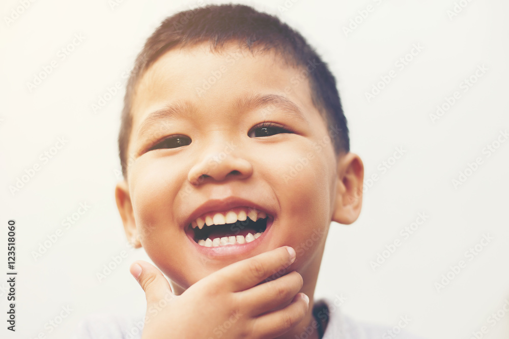 Happy boy laugh looking at camera portrait with isolate white ba Happy boy laugh looking at camera portrait with isolate white ba