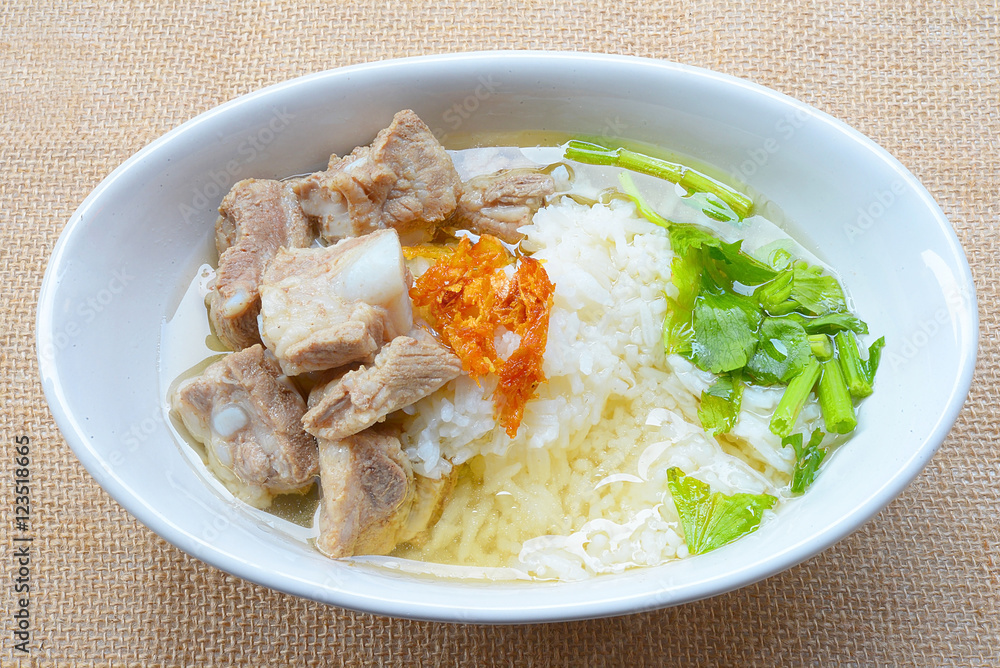 boiled rice with pork rib hot soup on bowl

