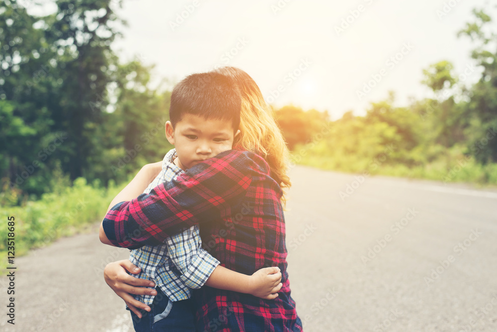 Little cute asian boy hug with her mom and smiling to camera hap Little cute asian boy hug with her mom and smiling to camera hap