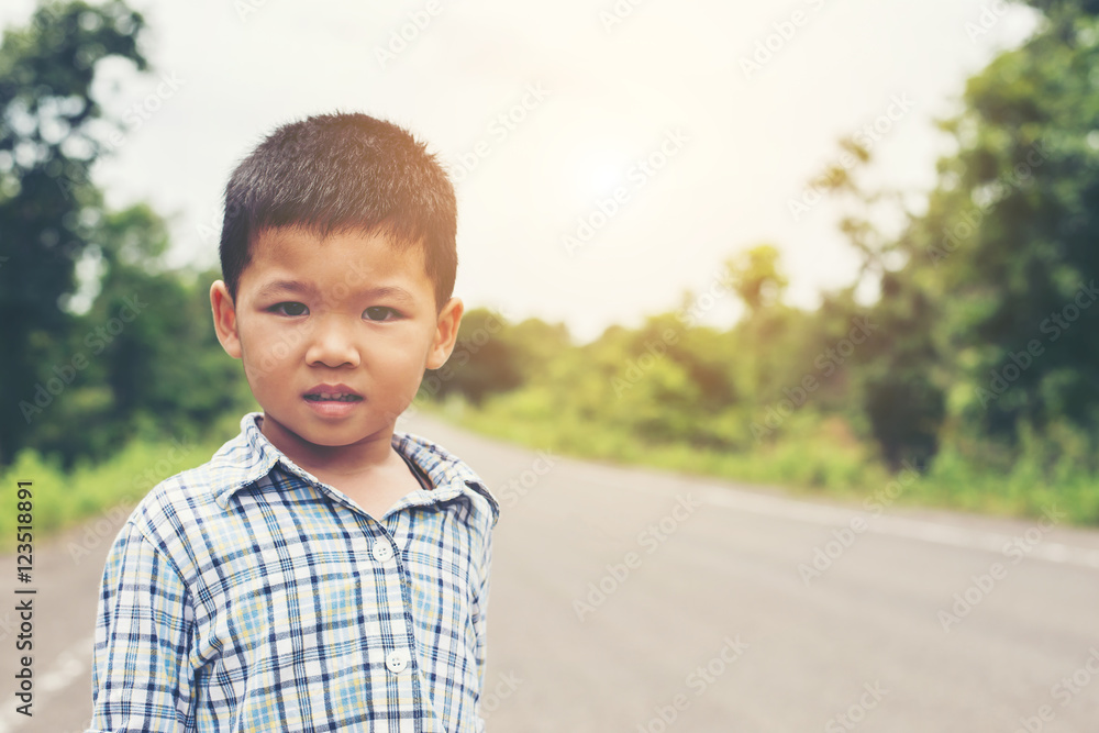 Portrait of a little cute asian boy in the park, smiling at the Portrait of a little cute asian boy in the park, smiling at the