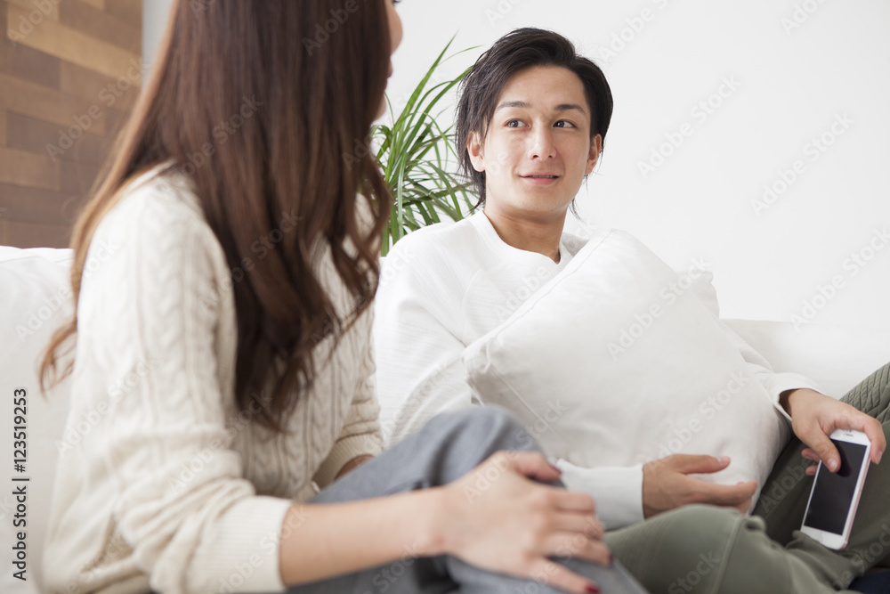 Young couple are talking happily in the living room Young couple are talking happily in the living room