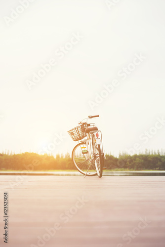Vintage toned of bicycle with basket on empty pier, summer day.