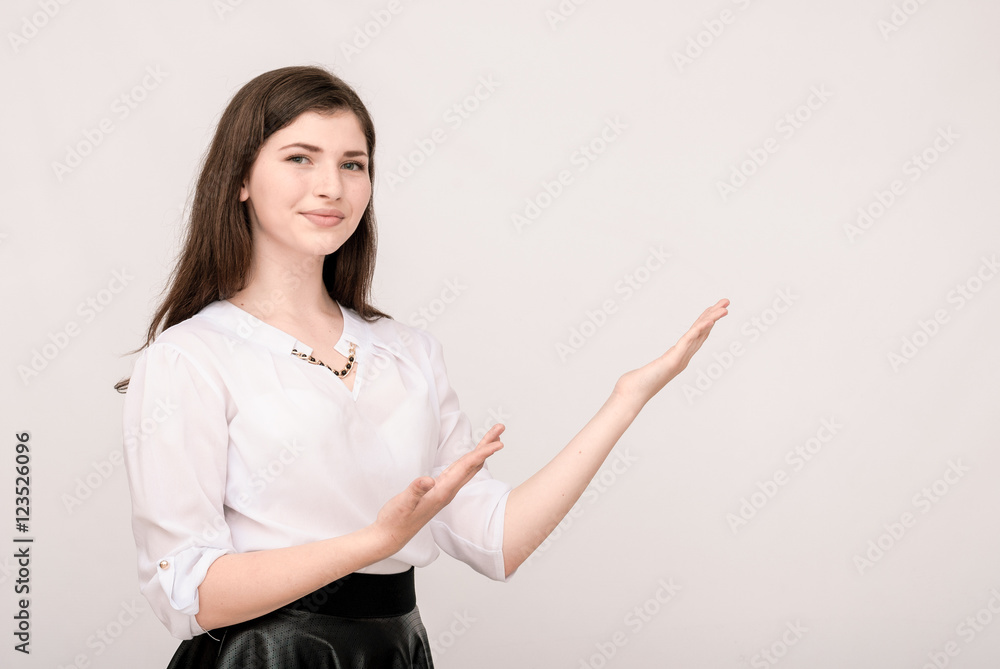 Smiling girl showing blank copy space for product or text. Smiling girl showing blank copy space for product or text.