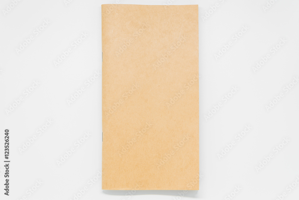 Brown plain notebook on white background and selective focus