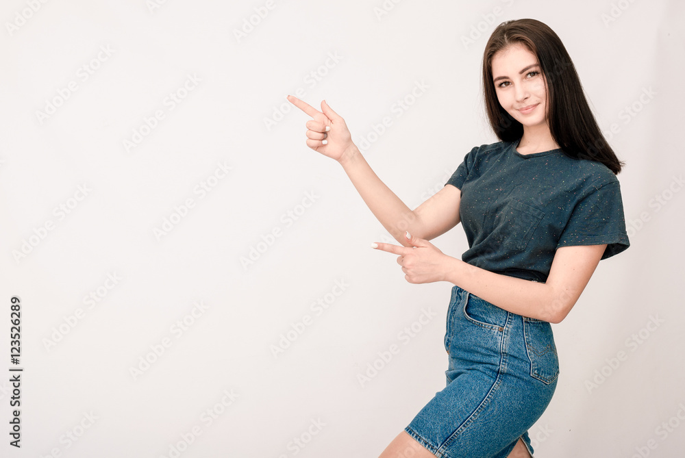 Smiling girl showing blank copy space for product or text. Smiling girl showing blank copy space for product or text.