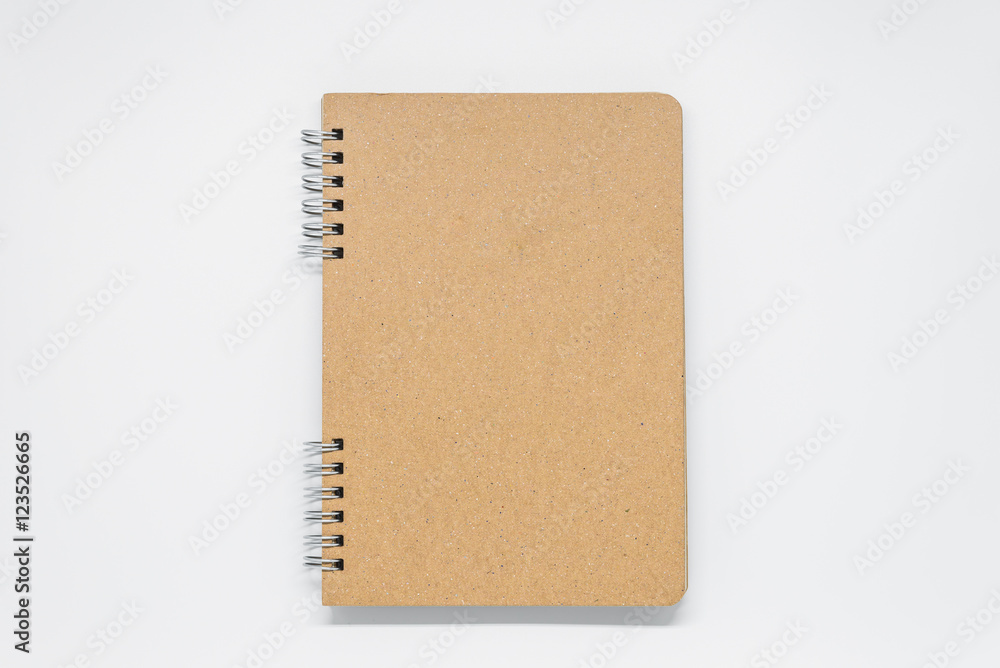 Brown plain notebook with ring on white background and selective focus Brown plain notebook with ring on white background and selective focus