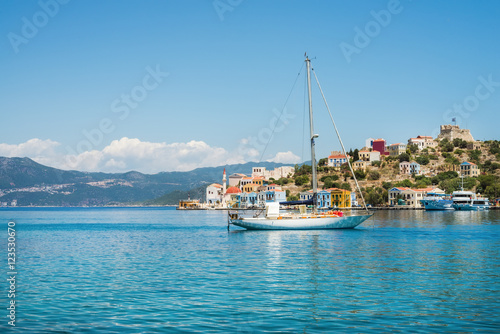 Yacht in bay of Kastelorizo island on sunny summer day, Dodecanese, Greece photo