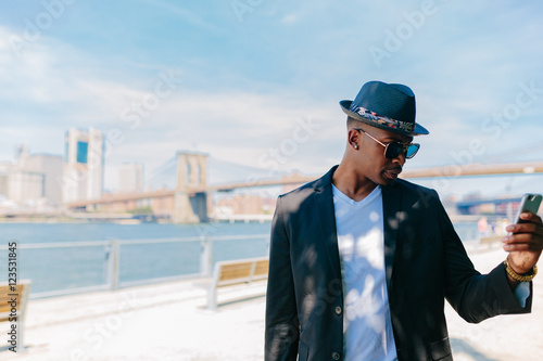 Wallpaper Mural Young Fashionable Businessman Using a Mobile Phone. Manhattan Background New York City Torontodigital.ca