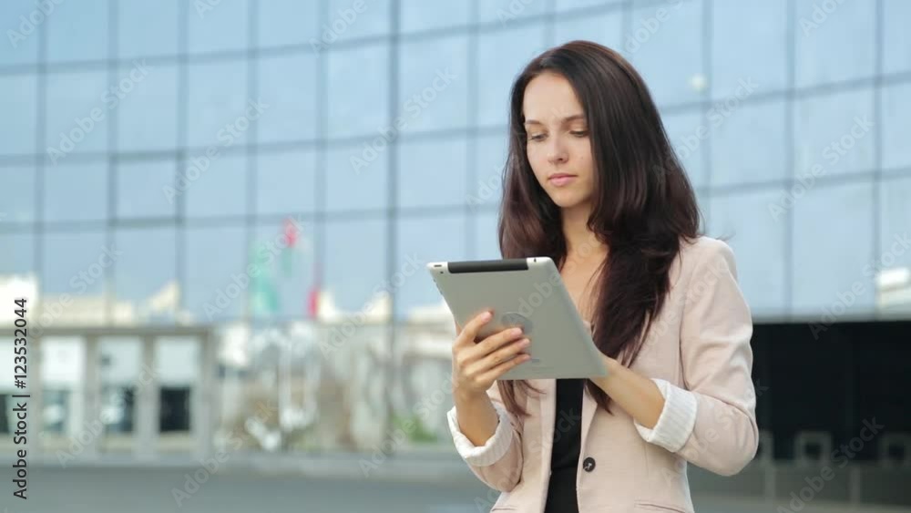 Pretty girl using tablet computer on the street Pretty girl using tablet computer on the street