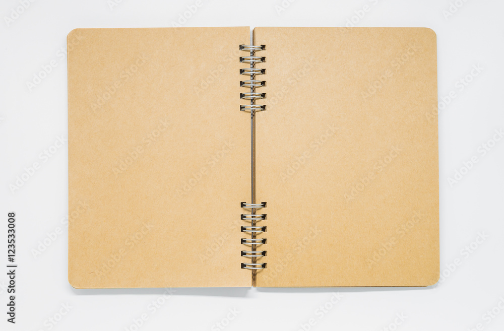 Opened Brown plain notebook with ring on white background and selective focus Opened Brown plain notebook with ring on white background and selective focus