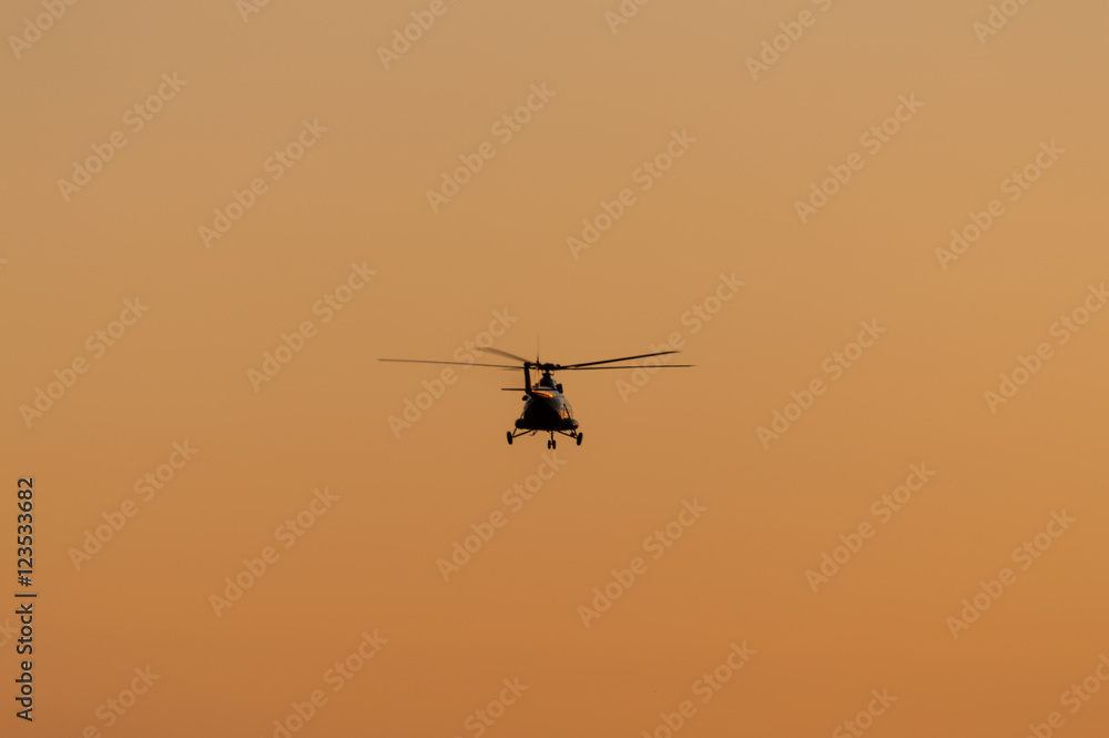 Silhouette of helicopter with sunset sky Silhouette of helicopter with sunset sky
