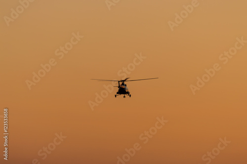 Silhouette of helicopter with sunset sky © Kazick