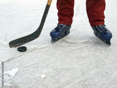 Ice hockey puck and kick and legs with skates 