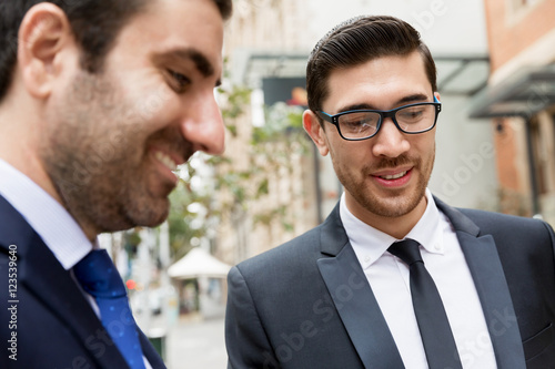 Two businessmen talking outdoors