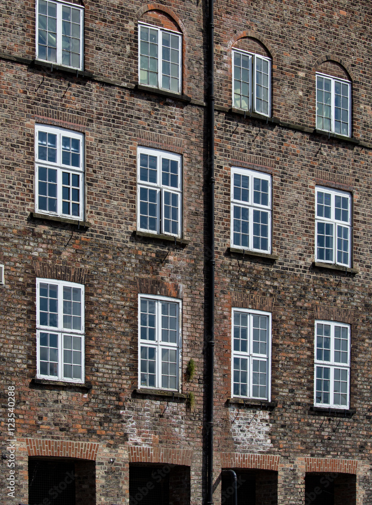 Fototapeta premium Brown Brick and Wooden Framed Windows