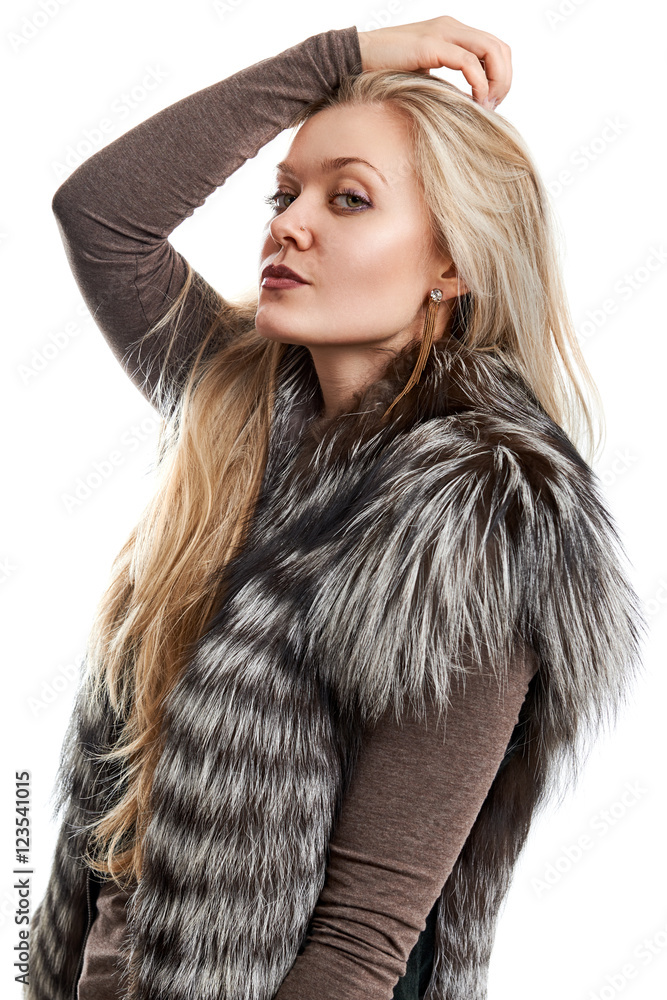 Portrait of a beautiful young woman in a fur vest on a white background Portrait of a beautiful young woman in a fur vest on a white background