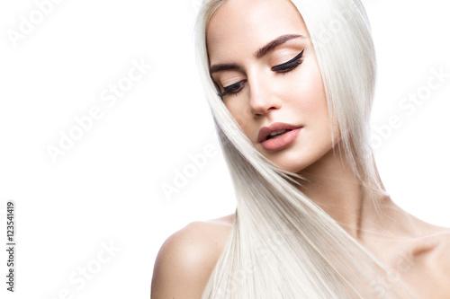 Fotótapéta Beautiful blond girl in move with a perfectly smooth hair, and classic make-up