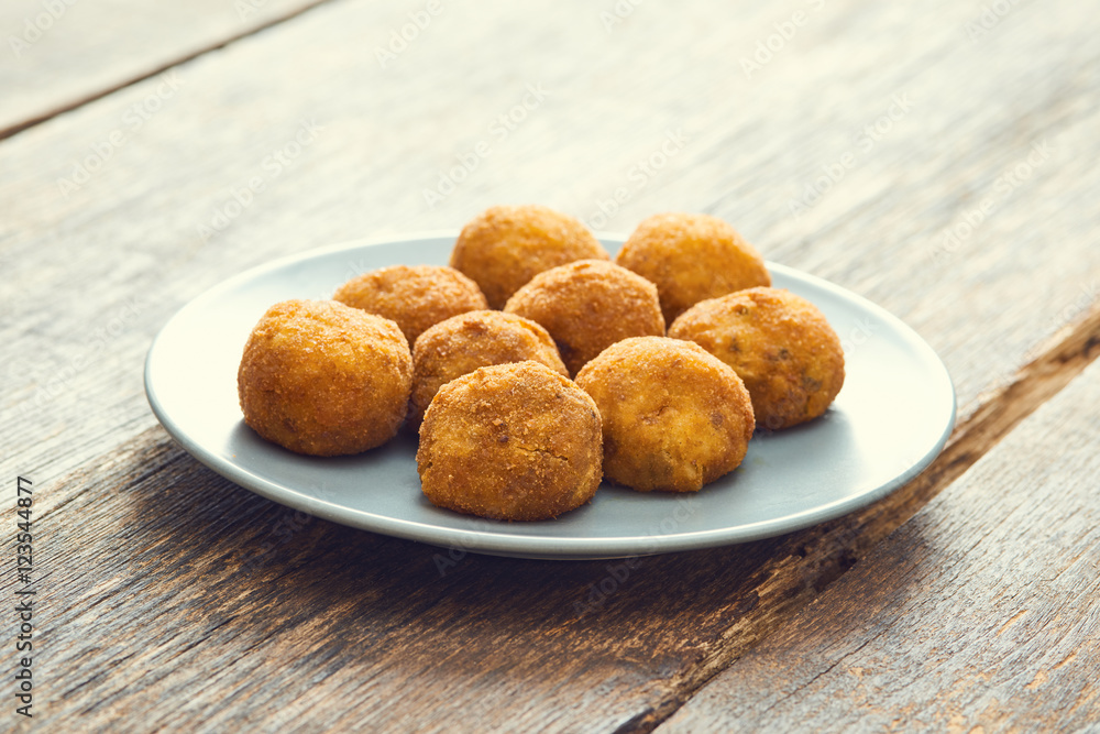 Arancini sicilian street food - rice balls stuffed with meat cooked Arancini sicilian street food - rice balls stuffed with meat cooked