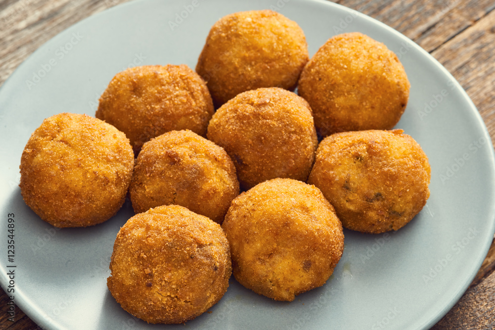 Arancini sicilian street food - rice balls stuffed with meat cooked Arancini sicilian street food - rice balls stuffed with meat cooked