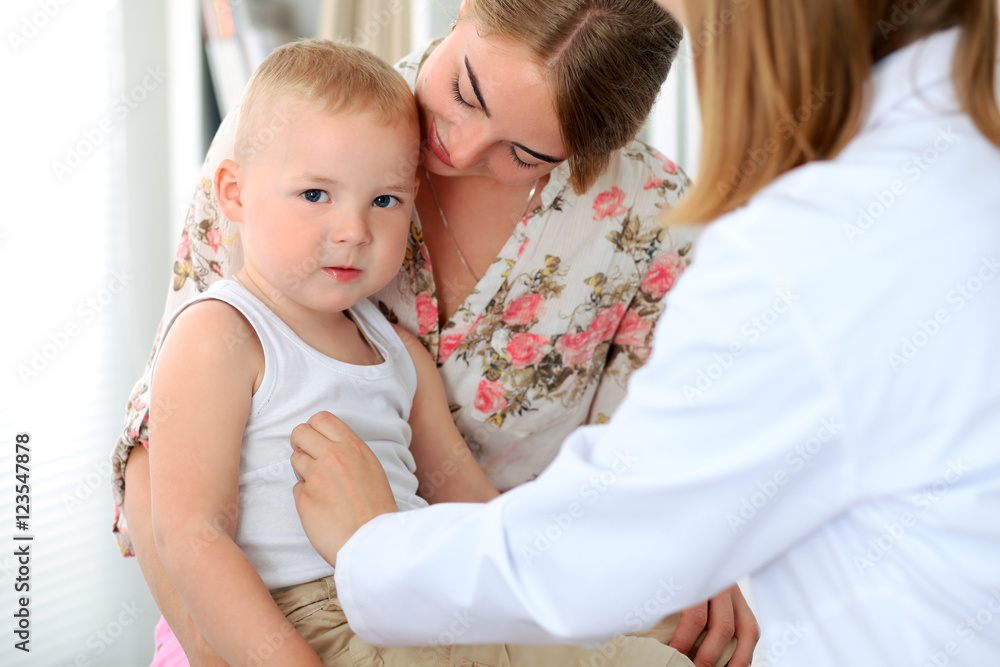 Doctor examining a child patient by stethoscope Doctor examining a child patient by stethoscope