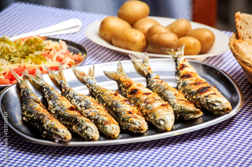 Grilled sardines with salad  bread and potato