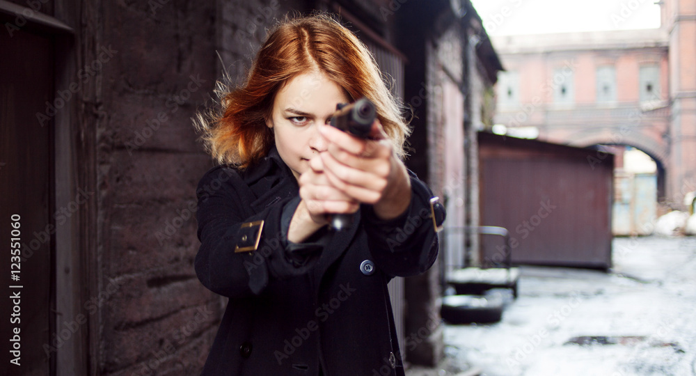 Woman pointing a gun. Mafia girl shooting at someone on the street. Woman pointing a gun. Mafia girl shooting at someone on the street.