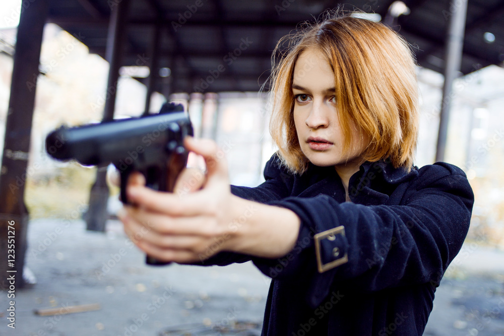 Woman pointing a gun. Mafia girl shooting at someone on the street. Woman pointing a gun. Mafia girl shooting at someone on the street.