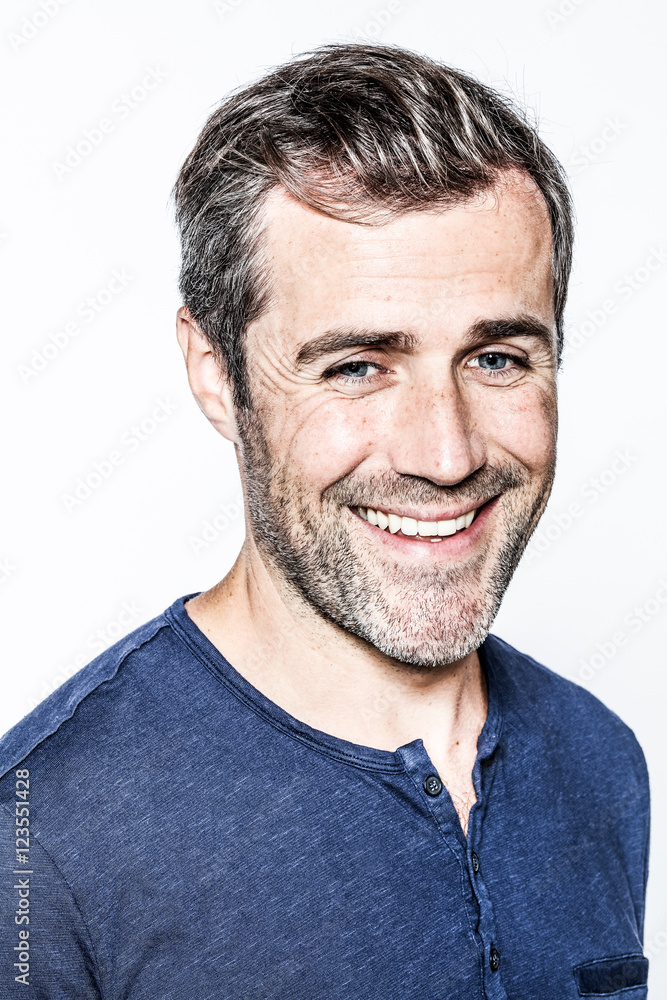 smart young bearded man with salt and pepper hair smiling smart young bearded man with salt and pepper hair smiling