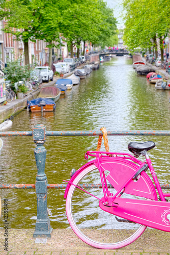 Pink bike on a stopover in Amsterdam canal