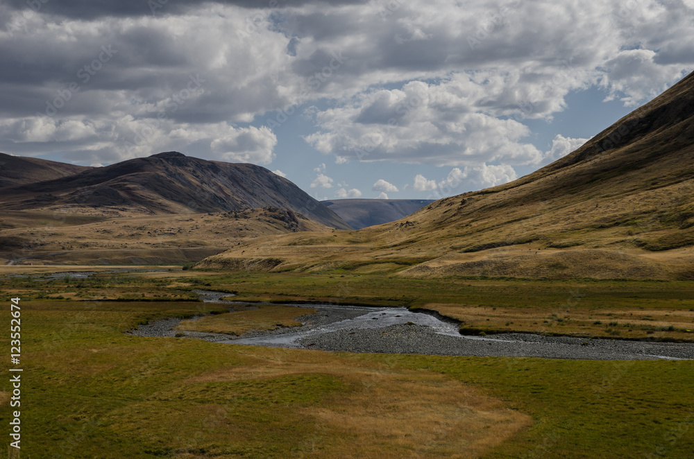 Wildlife Altai. The river, mountains and sky with clouds in summ