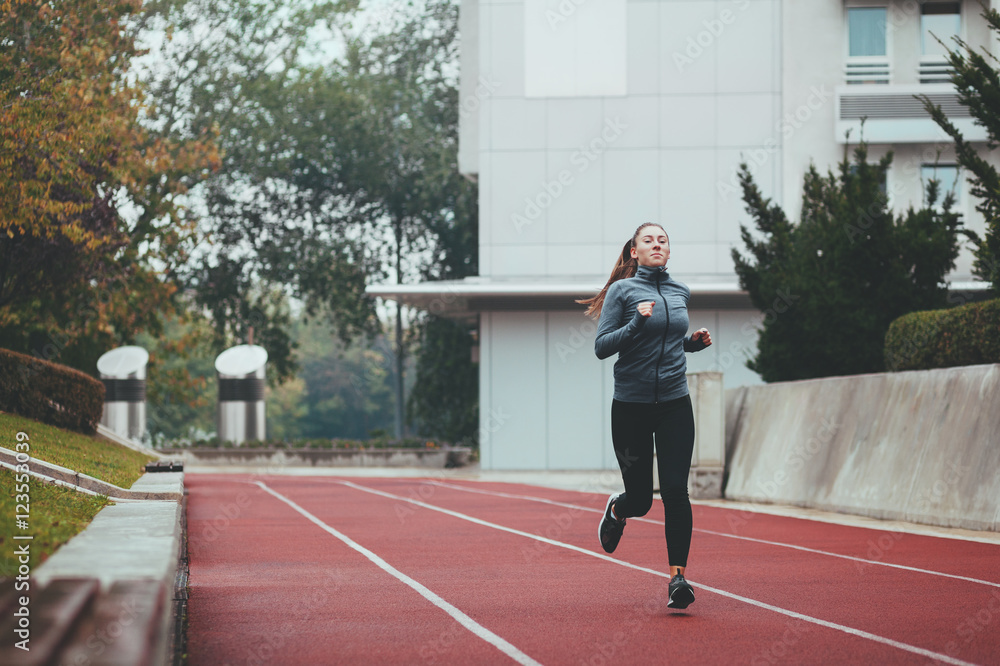 Fototapeta premium Young woman jogging on a cold day