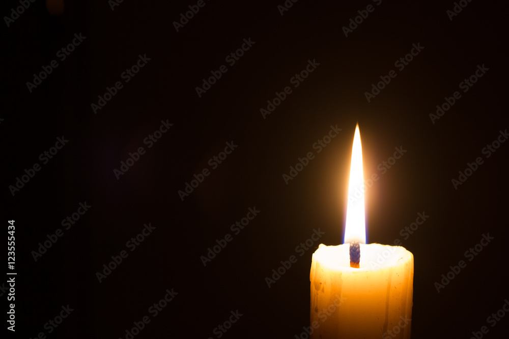 horizontal photo of closeup candle on black background with copyspace horizontal photo of closeup candle on black background with copyspace