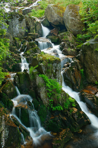 Small Waterfall Cascading over Huge Rocks
