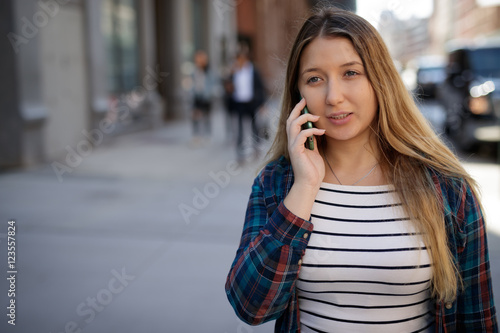 Young woman in city talking on cell phone