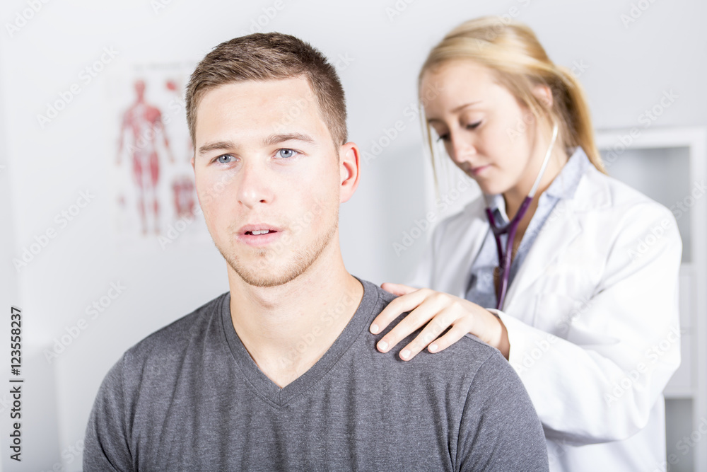 Doctor examining her patient in medical office Doctor examining her patient in medical office
