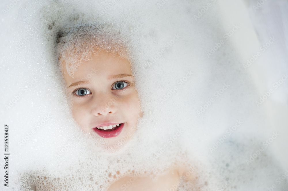 Overhead view of happy girl taking bubble bath Overhead view of happy girl taking bubble bath