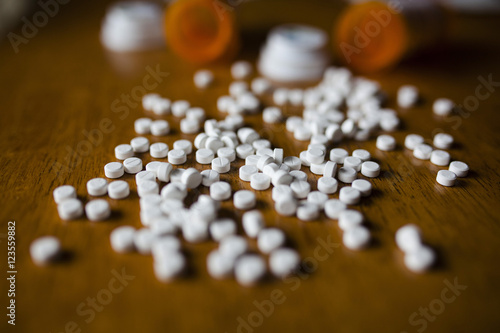 Close-up of pills and bottles on table photo