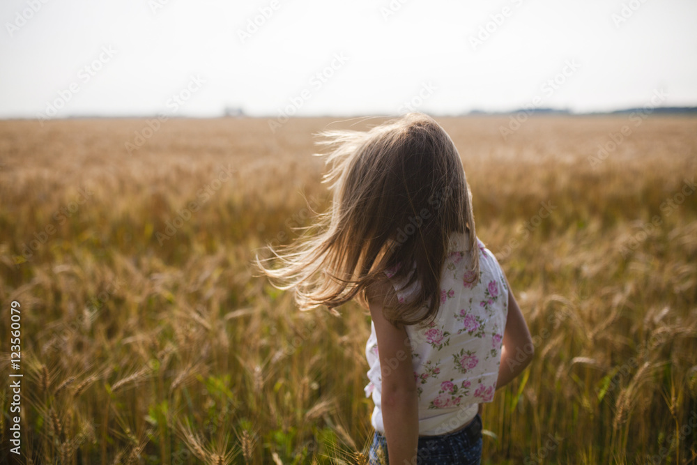 Rear view of girl standing in farm Rear view of girl standing in farm