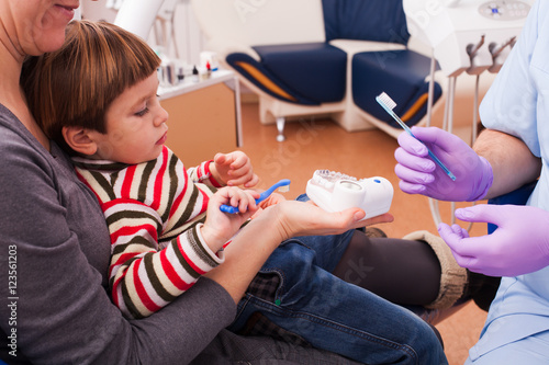 Mom and her little son visiting the dentist