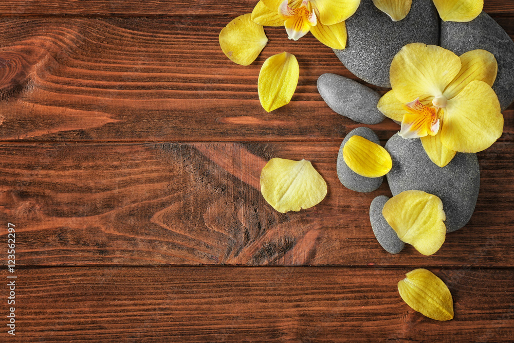 Fototapeta premium Spa stones with orchid flowers, top view