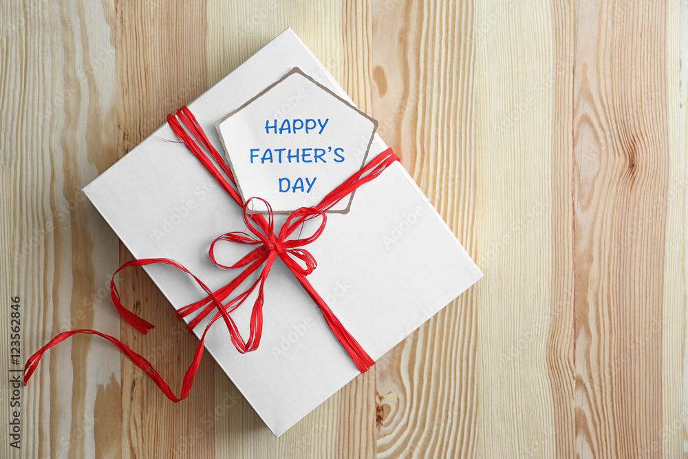 Gift box for fathers day on wooden background Gift box for fathers day on wooden background