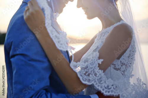 Groom and bride kissing, ou...
