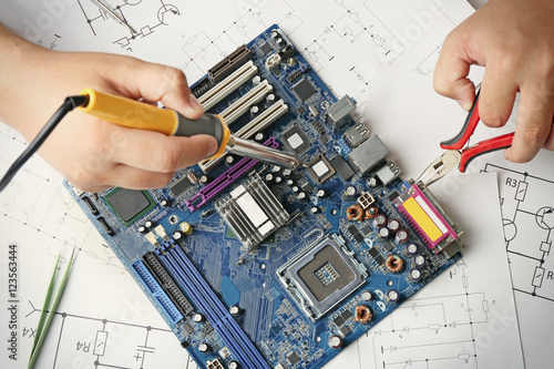 Man using soldering tool fo...