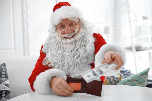 Santa Claus holding wallet ...