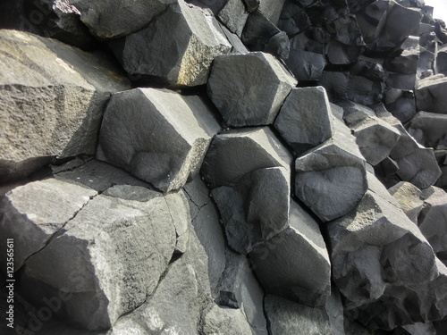 Hexagonal basalt columns geological rock formation in Iceland photo