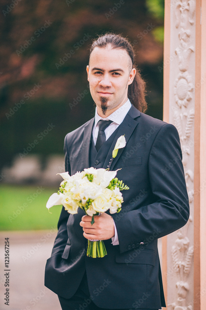 Young stylish man in a suit. Groom with long hair beard and piercing. Young stylish man in a suit. Groom with long hair beard and piercing.