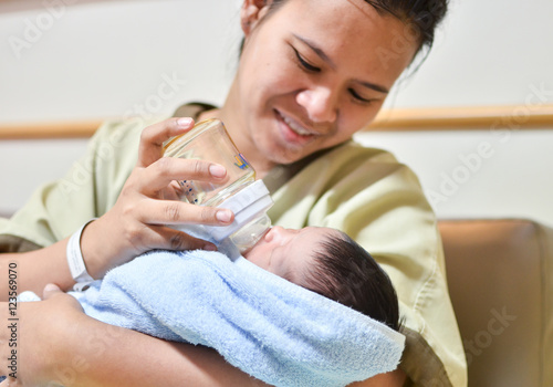 mother is feeding her newborn baby in the hospital