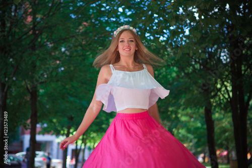 Portrait of a beautiful young girl in the Park skirt